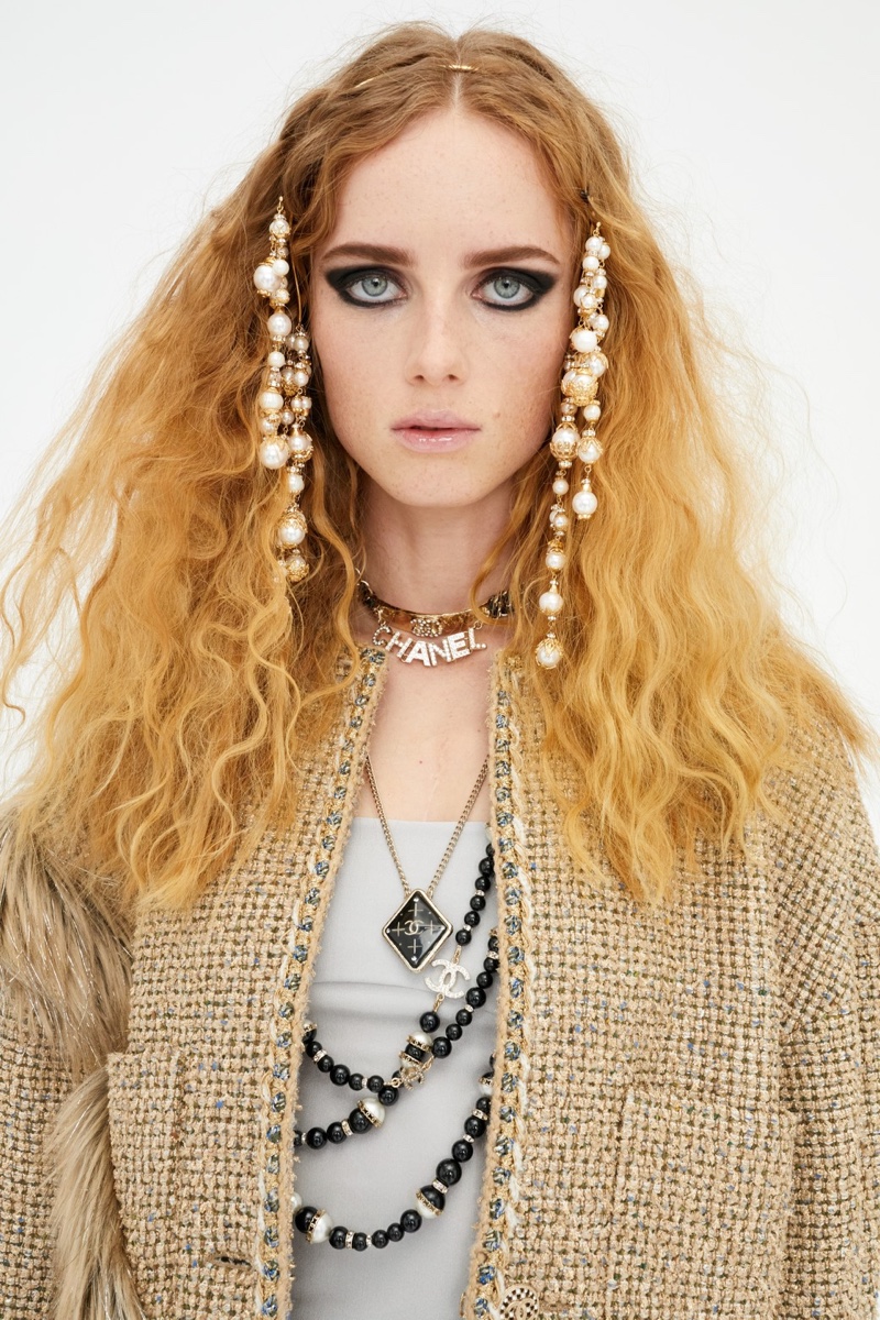 Chanel features layered jewelry in pre-fall 2021 collection.