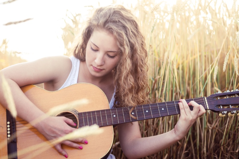 Girl Playing Guitar Outdoors
