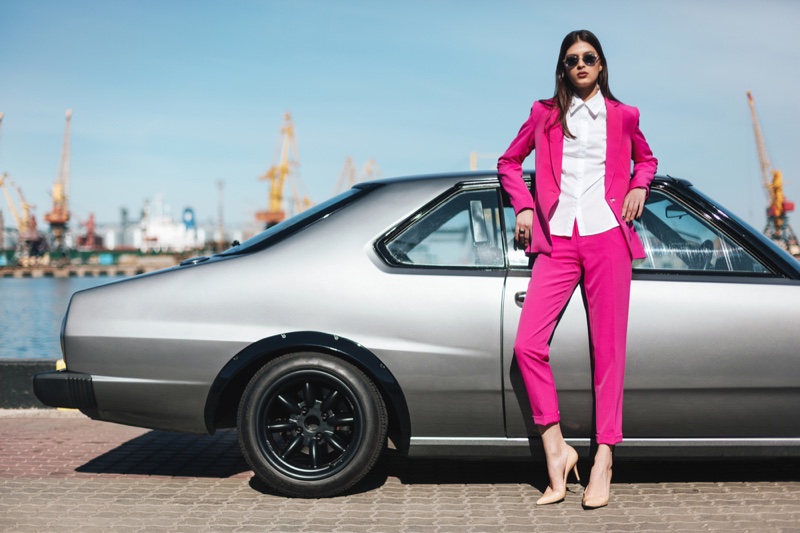 Model Hot Pink Pantsuit Posing Next to Car