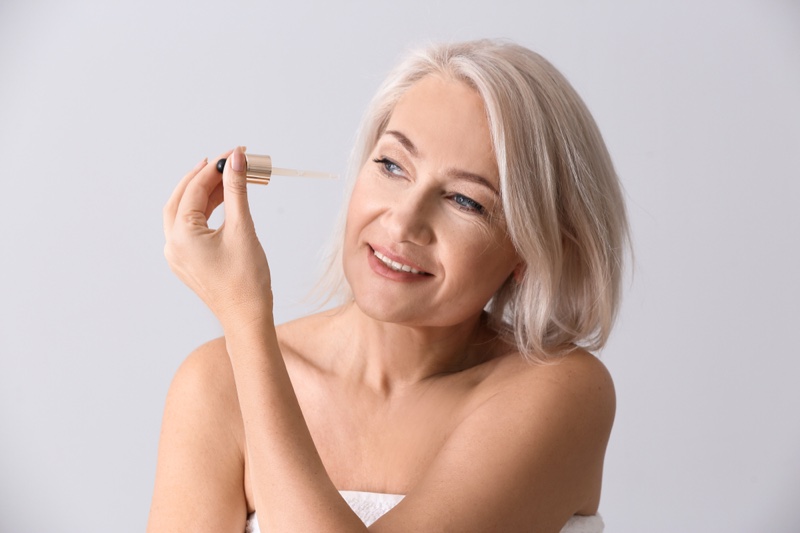 Woman Applying Serum Mature Anti-Aging