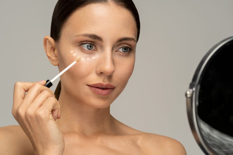 Woman Putting on Concealer