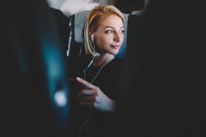 Woman Traveling Listening Earphones