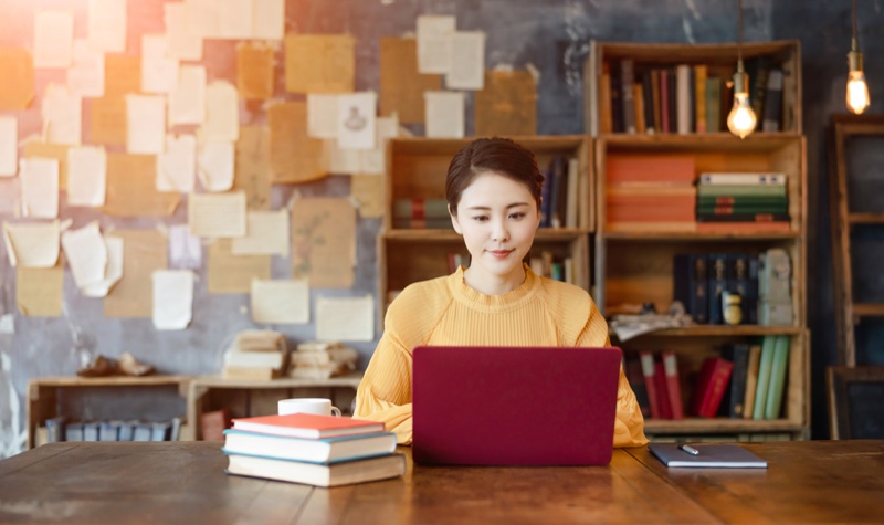 Asian Woman Laptop Books Desk