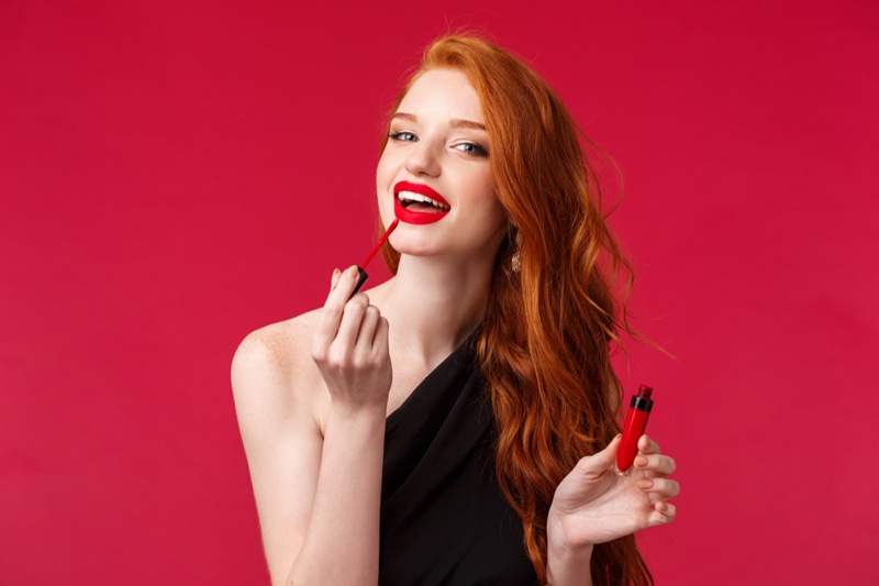 Redhead Woman Applying Red Liquid Lipstick