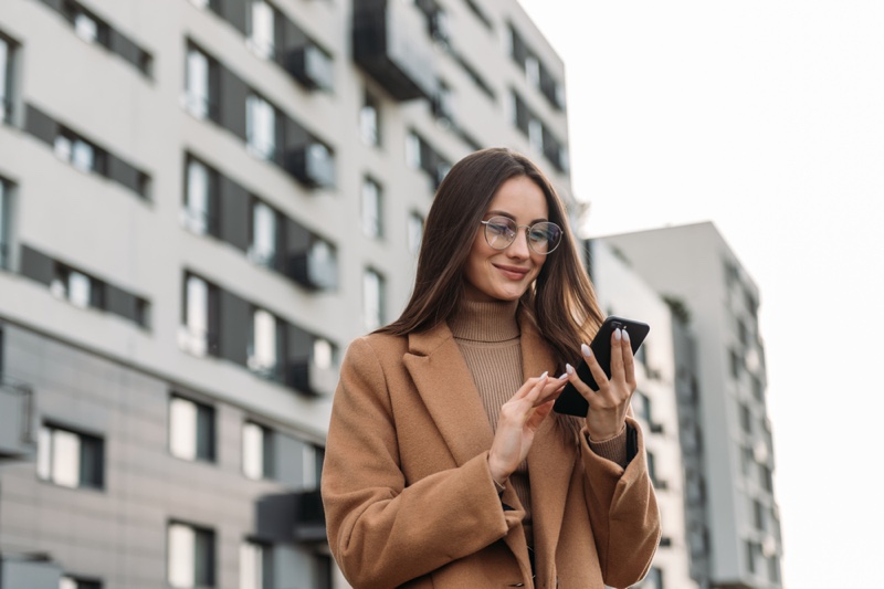 Stylish Woman Brown Coat Glasses Looking Phone