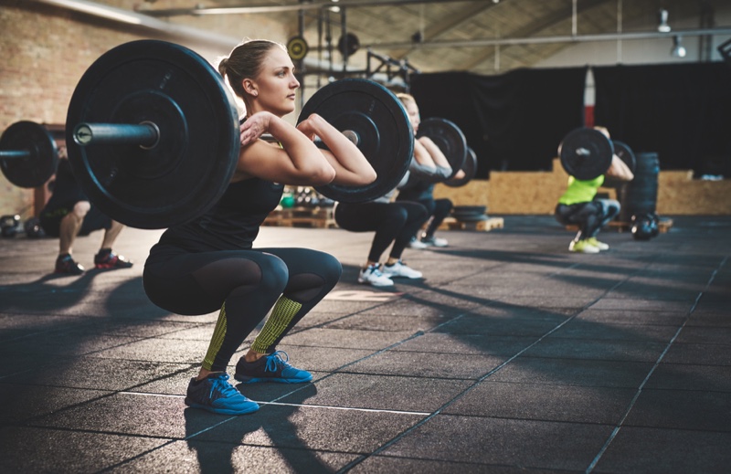 Woman Squatting Lifting Weight Bar