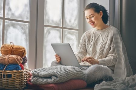How To Protect Yourself While Playing Bingo Online Woman Stylish Cable Knit Sweater Blanket Laptop Relaxation