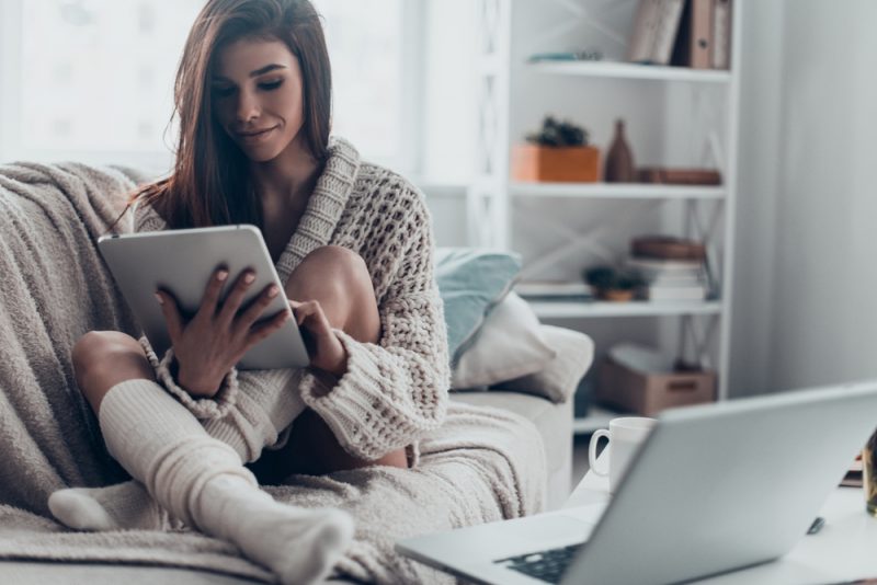 Woman in Oversized Sweater and Socks on Couch