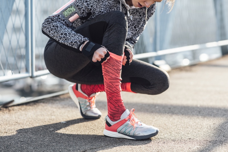 Activewear Female Runner Pulling Pink Socks Sneakers