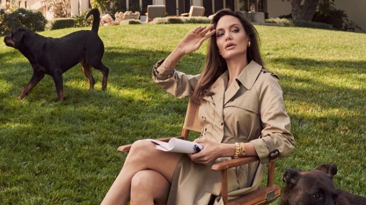 Posing with her dogs Dusty and Sophia, Angelina Jolie wears a Dior trench coat.