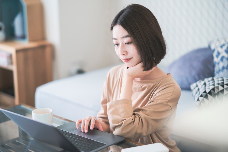 Asian Woman Viewing Laptop
