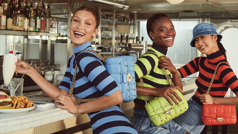 Models Bella Hadid, Mayowa Nicholas, and Heejung Park pose for MICHAEL Michael Kors spring-summer 2021 campaign.