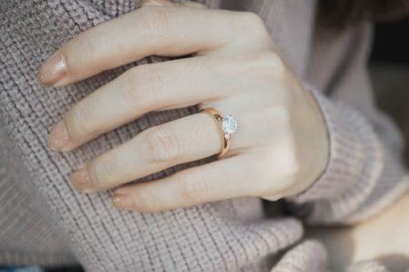 Things to Consider When Choosing an Engagement Ring Closeup Woman's Hand Engagement Ring Gold Band