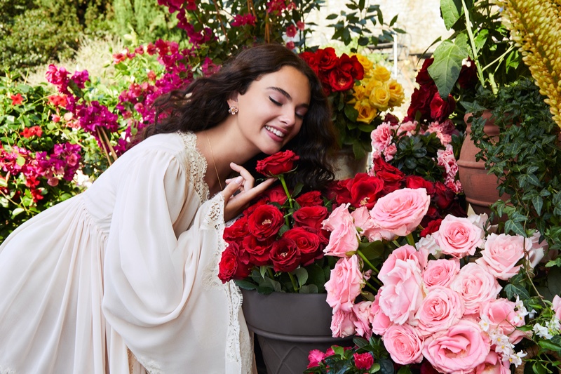 BEHIND THE SCENES: Smelling flowers, Deva Cassel poses on set of Dolce & Gabbana fragrance shoot.