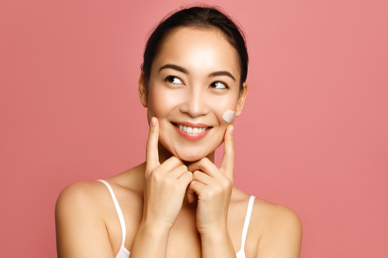Happy Asian Woman Skincare Face Product