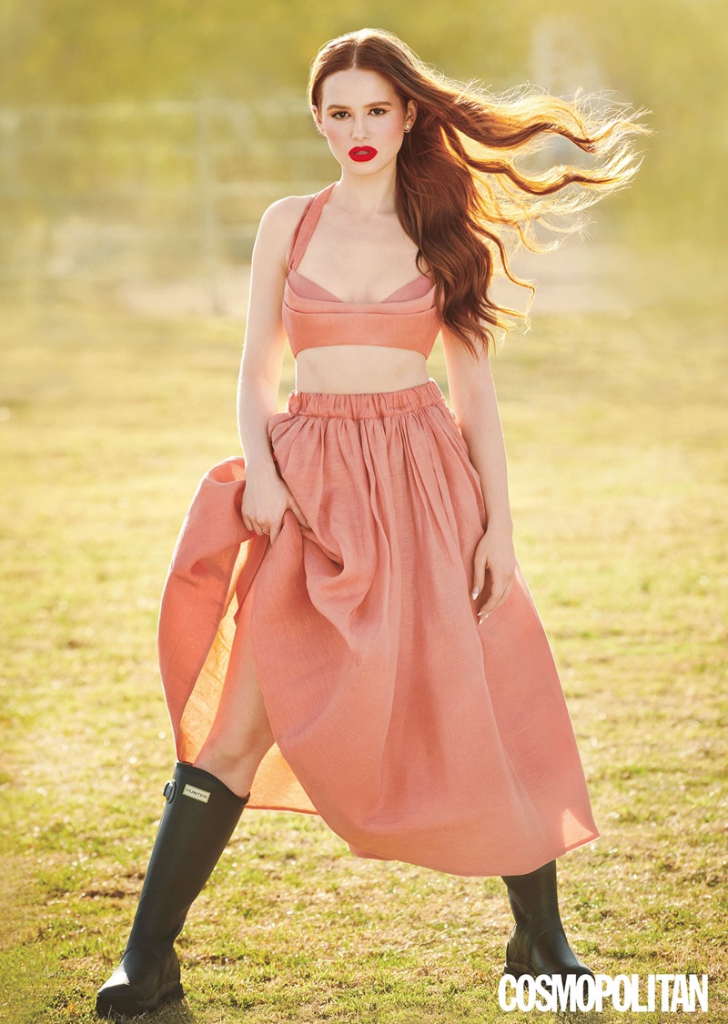 The Riverdale star poses in Zimmermann bustier and skirt, Hunter boots, and Cartier jewelry.
