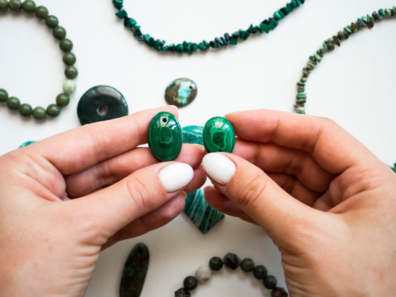 Malachite Stones Holding Painted Nails