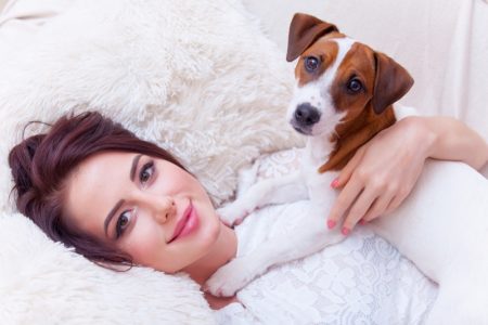 Top Tips for Creating a Pet's Corner Model Smiling Holding Dog Laying Down