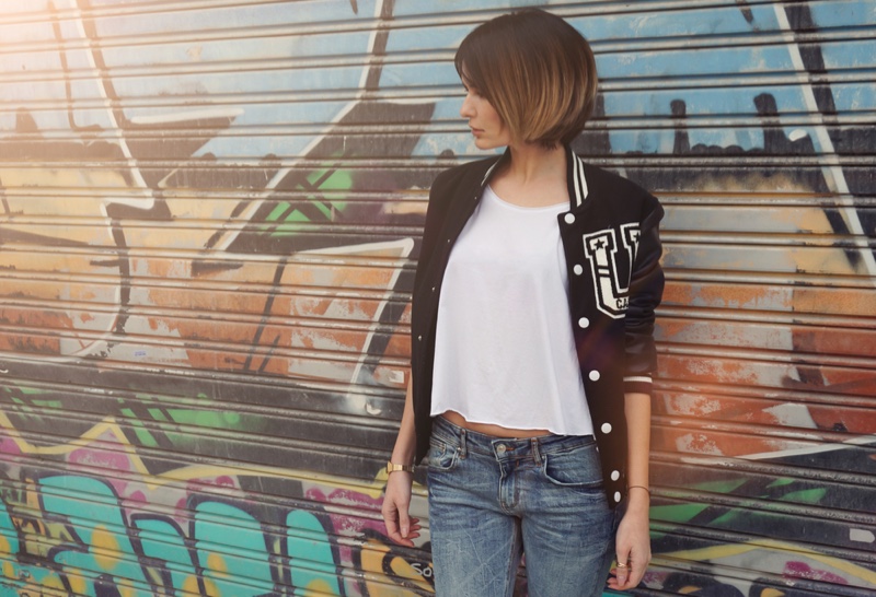 Model Wearing Letterman Jacket White T-Shirt Jeans Graffiti Background