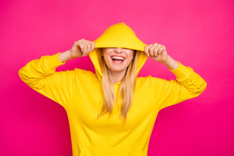 Smiling Blonde Model Yellow Hoodie Hood Up Covering Face