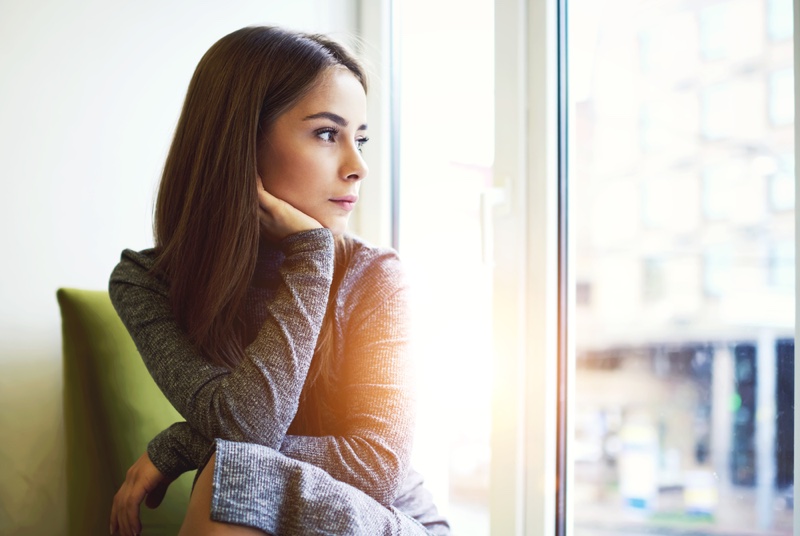 Thoughtful Depressed Woman Looking Out Window