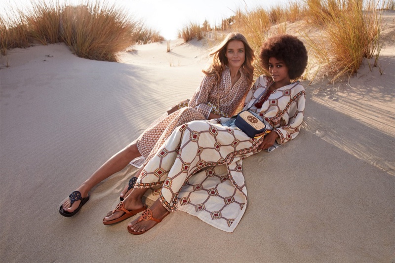 Natalia Vodianova and Blesnya Minher pose on the beach for Tory Burch spring-summer 2021 campaign.