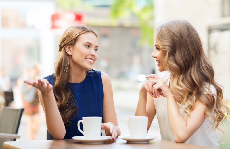 Two women Talking Outdoors Cups