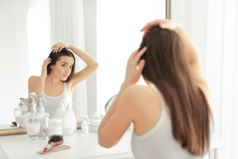 Woman Bathroom Mirror Checking Hair