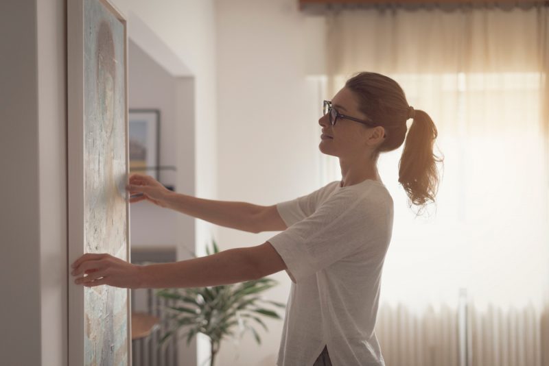 Woman Hanging Painting