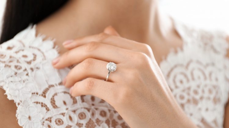 Woman Wearing Diamond Engagement Ring Lace Top