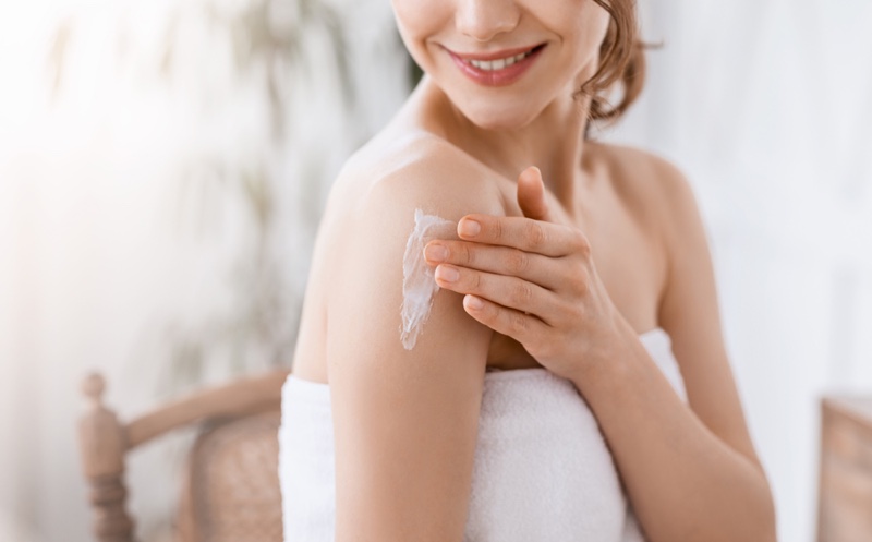 Cropped Image Smiling Woman Applying Cream Shoulder