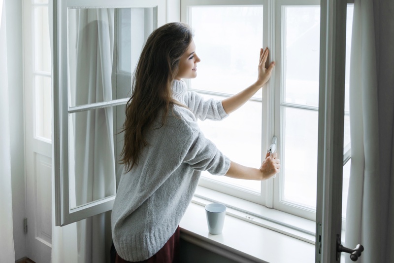 Happy Woman Closing Window