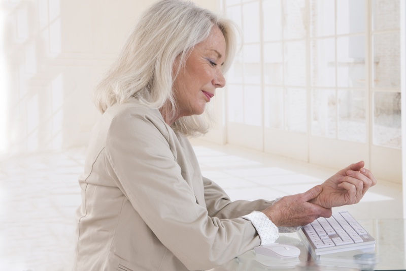 Older Woman Grey Hair Holding Wrist Keyboard