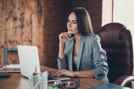How to Dress for Respect in the Real Estate Industry Professional Woman at Desk