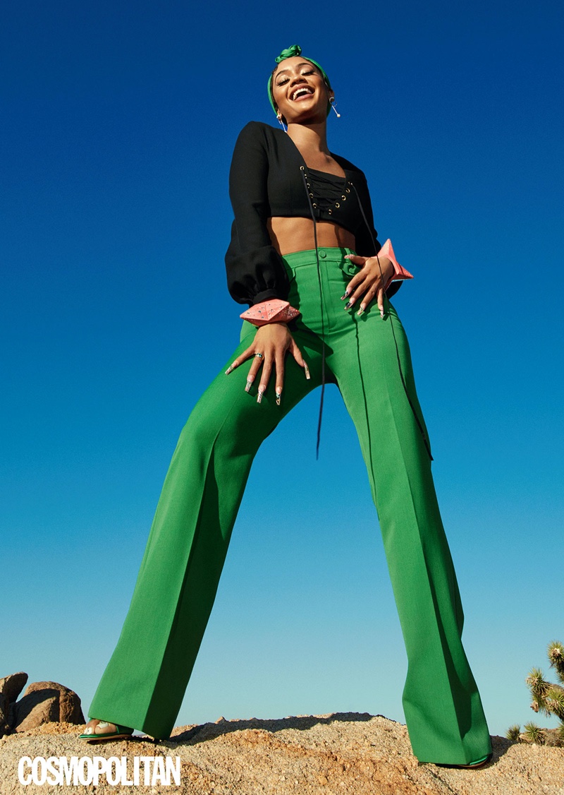 Taking a stand, Saweetie wears Gucci top, pants, carré, and bracelets with Giuseppe Zanotti heels.