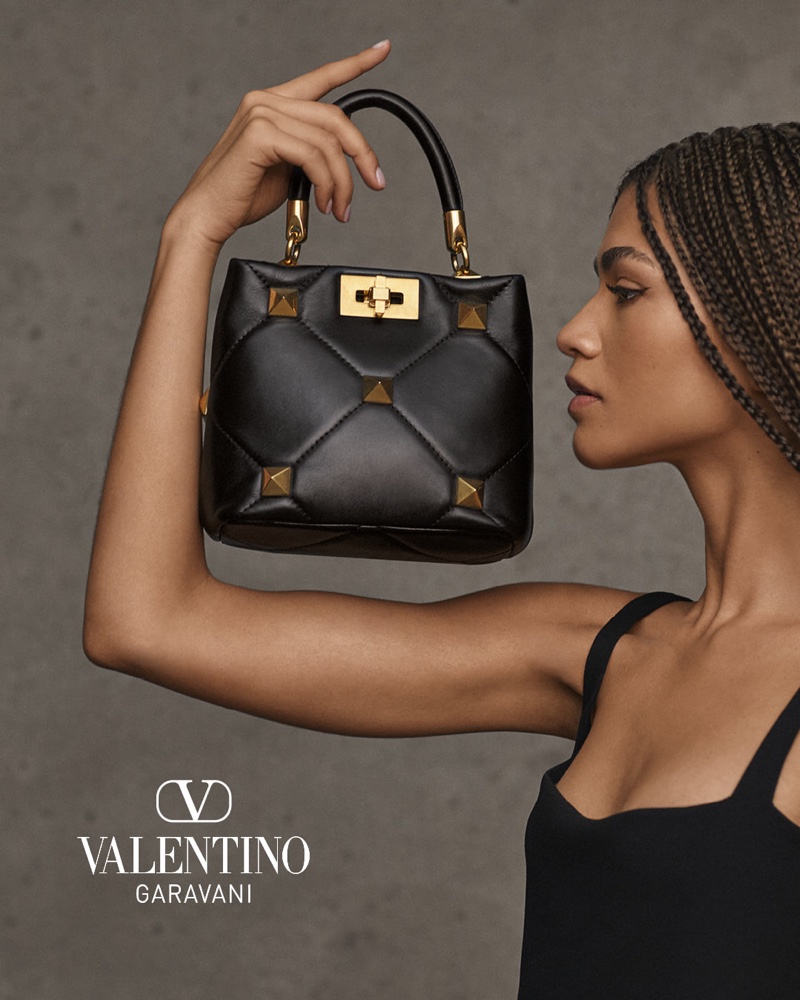 Actress Zendaya poses with Valentino Roman Stud top handle bag.