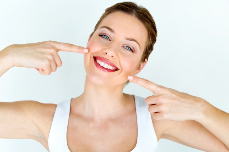 Attractive Smiling Woman Pointing Mouth