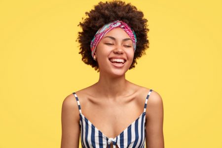 Why Headband Wigs Are So Popular Smiling Model Headband Striped Top Afro Hairstyle