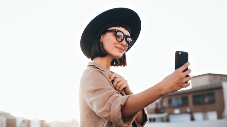 How Social Media Influences the Fashion World? Stylish Woman Hat Phone Influencer Social Media