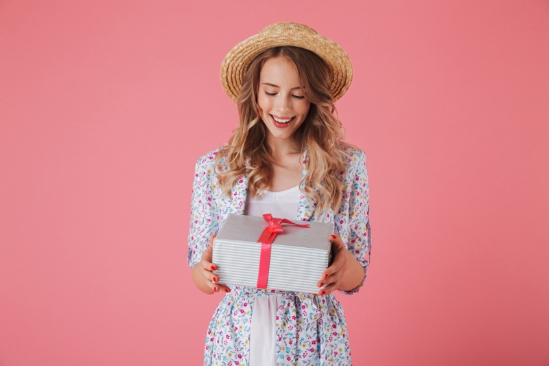 Stylish Woman Happy Holding Gift Box