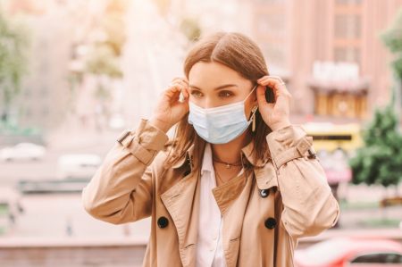 Solo Traveling: Why Do You Deserve Some Time Off? Woman Blue Face Mask Trench Coat Stylish City
