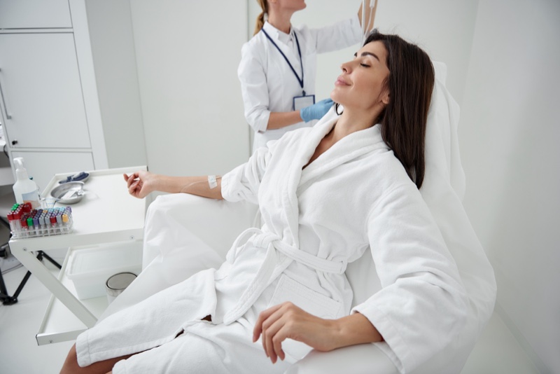 Woman Robe Receiving Infusion Treatment