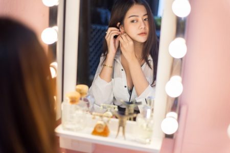 Why A Vanity Mirror With Bluetooth Speakers is a Good Choice Asian Woman Looking Vanity Mirror