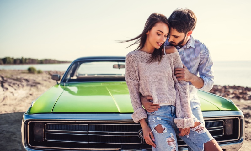 Attractive Couple Green Vintage Car Woman Ripped Jeans Sweater