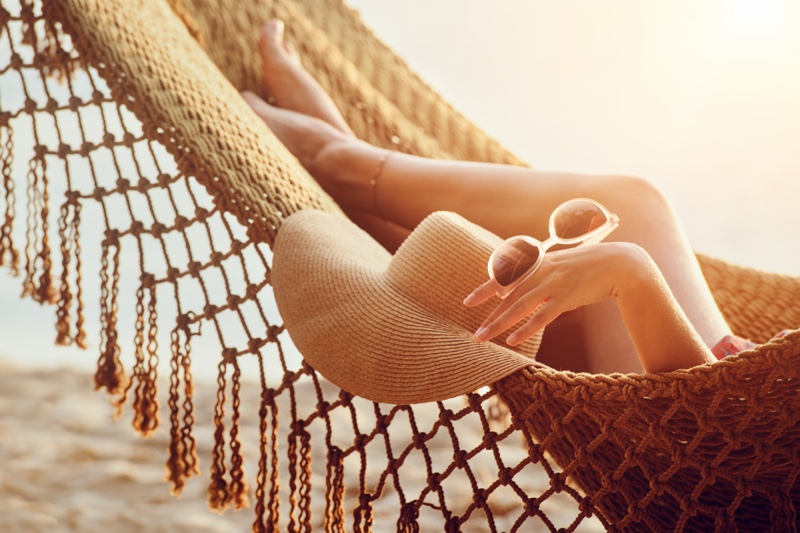 Cropped Image Model Hammock Beach Straw Hat Sunglasses Legs