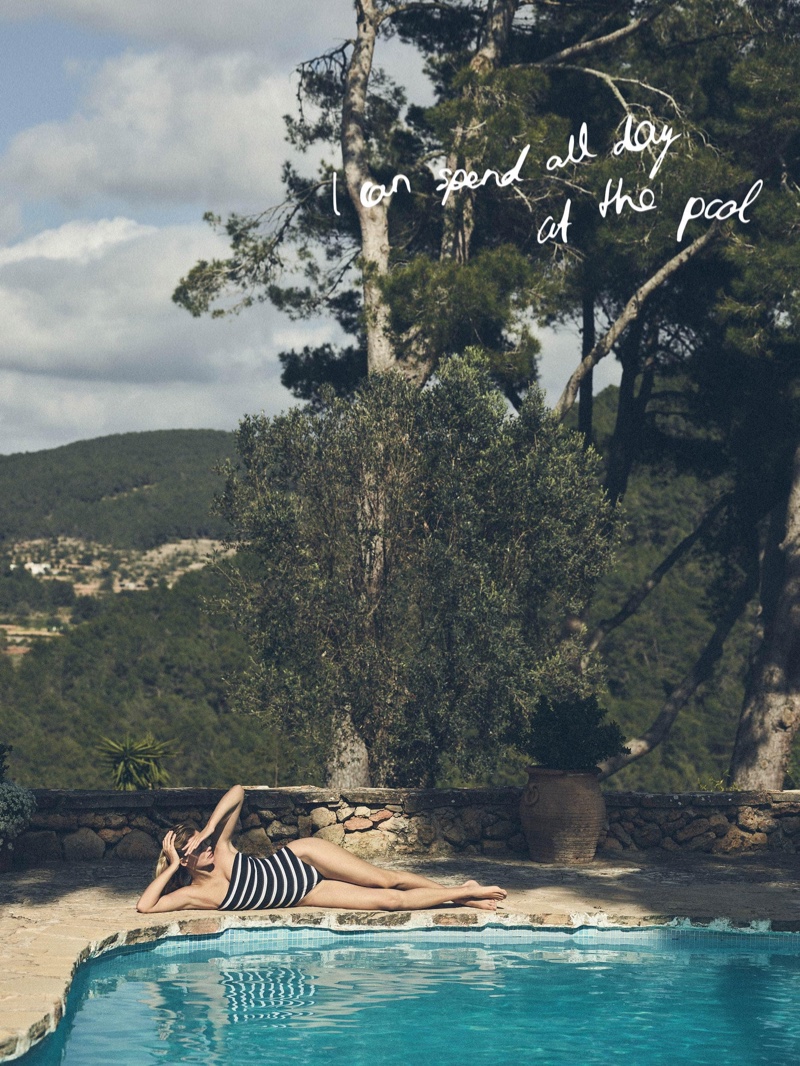 Posing poolside, Edita Vilkeviciute wears Zara Home striped swimsuit.