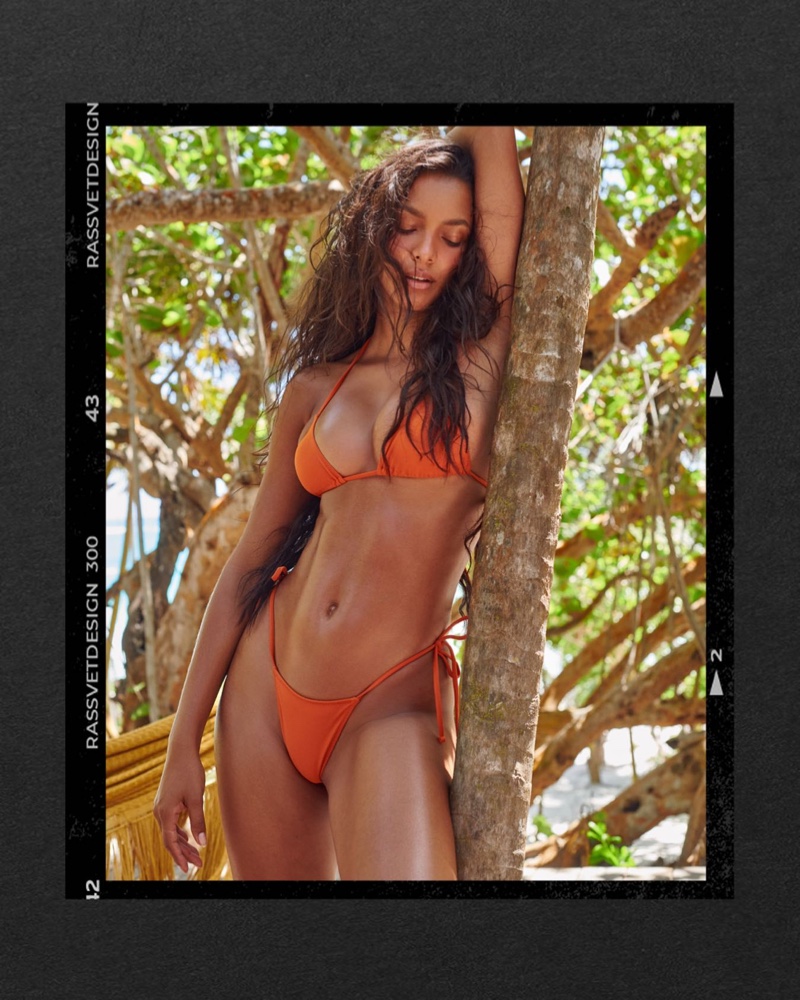 Lais Ribeiro wears Tropic of C Praia top and bottom in burnt orange.