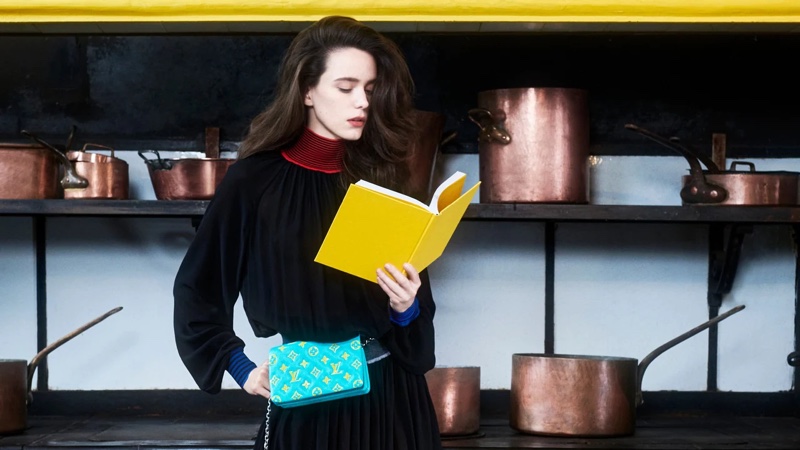 Reading a book, Stacy Martin fronts Louis Vuitton pre-fall 2021 campaign.