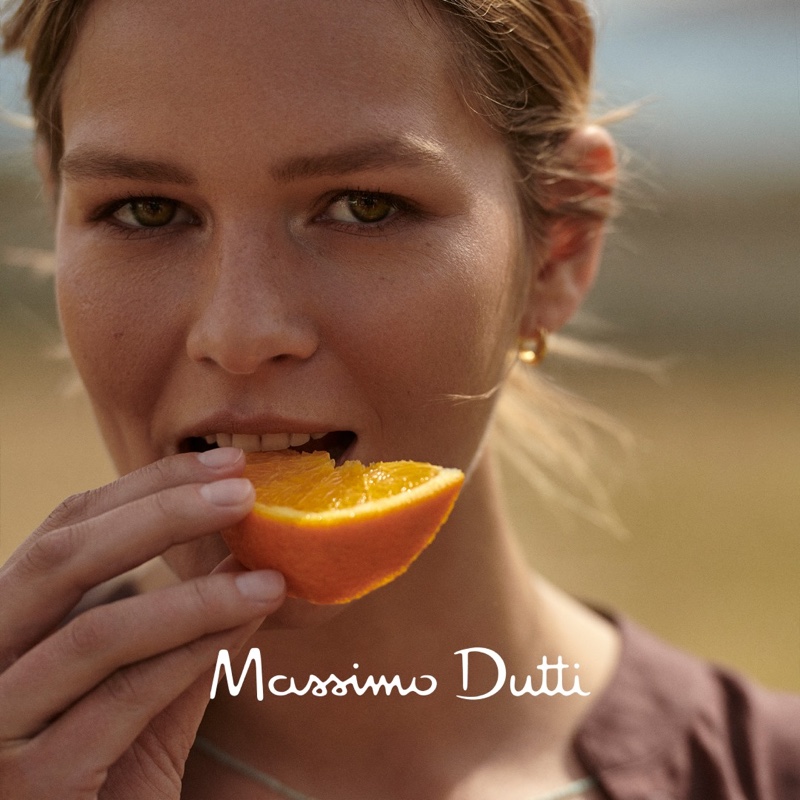 Anna Ewers eats an orange in Massimo Dutti style guide.