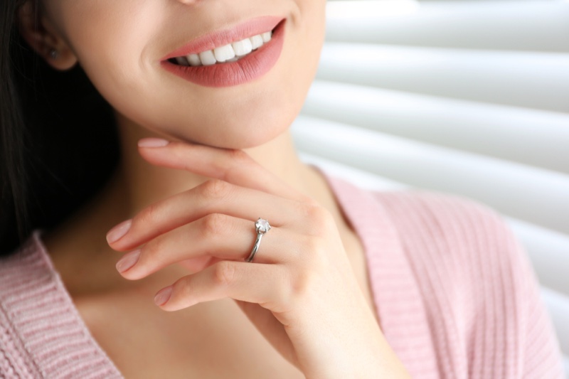 Smiling Woman Cropped Engagement Ring Hand